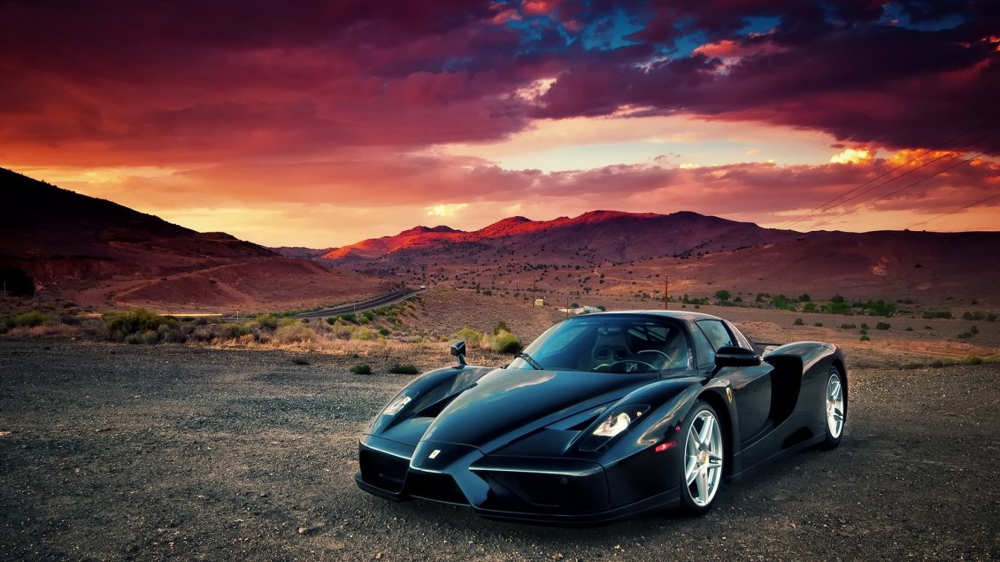 Download Wallpaper Black Enzo Ferrari in mountains in sunset