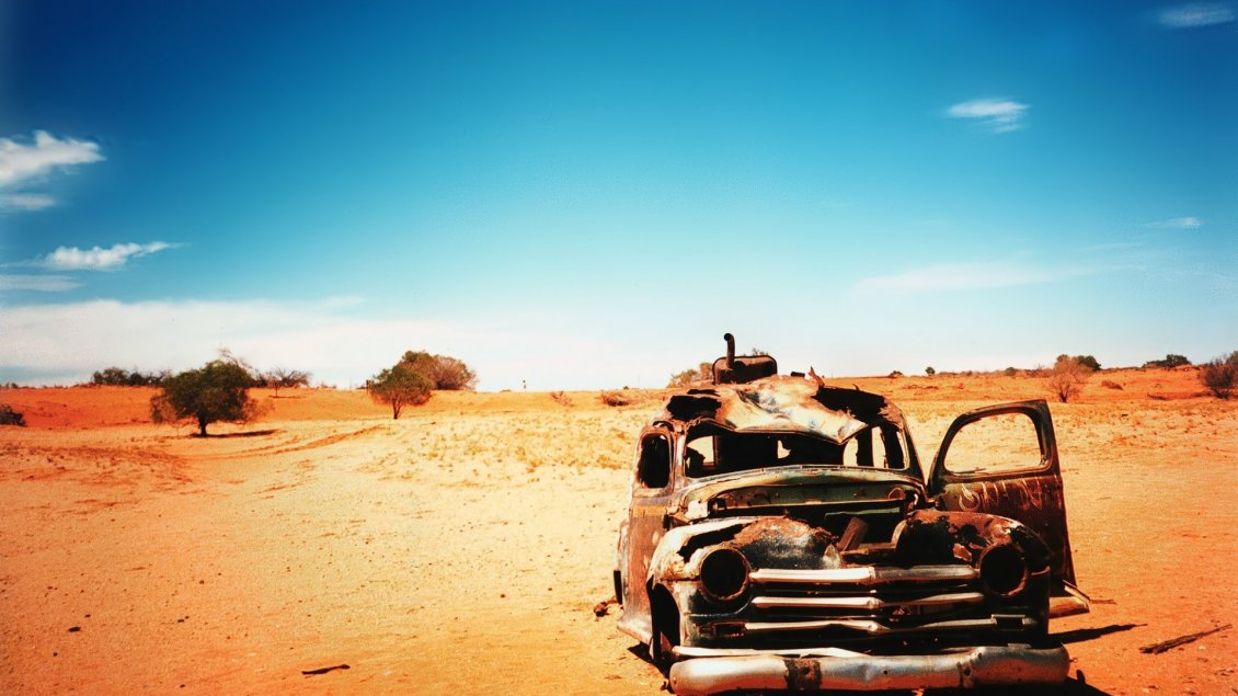 Download Wallpaper Old and very rusty classic car in the dessert