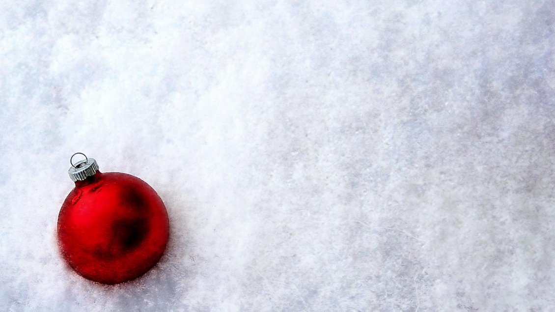 Download Wallpaper Shiny red Christmas ball in the white and cold snow
