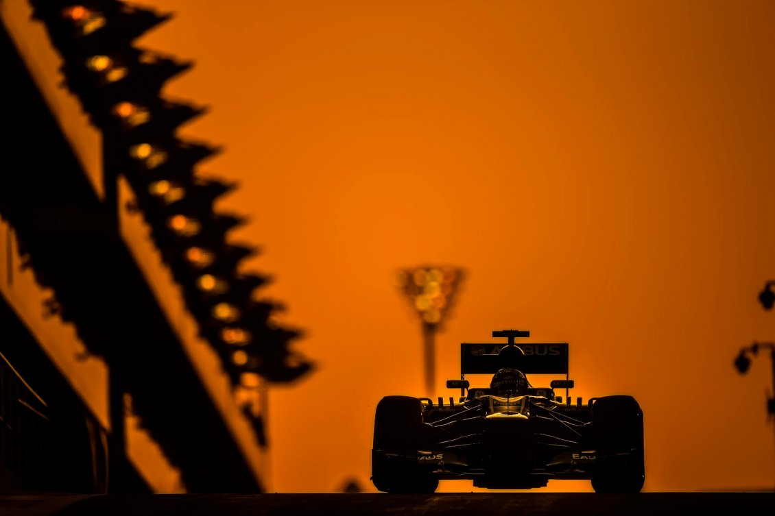 Download Wallpaper Formula 1 race car in the light of orange sunset