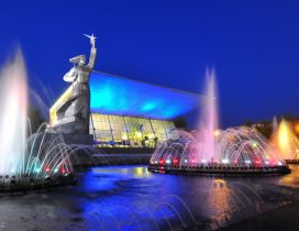 Fountains with colored lights and a statue