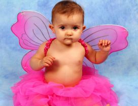 A sweet ballerina girl with pink butterfly wings