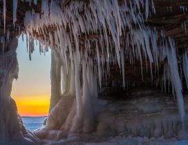 Sunset view from a cave full of icicle