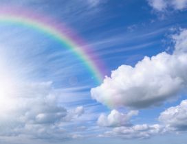 Rainbow over the blue sky