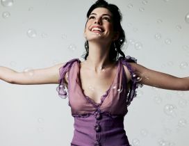 Anne Hathaway in high glee between balloons