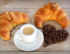 Two Croissants and a cup of Cappuccino Cafe