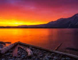 Orange sunset over a mountain lake