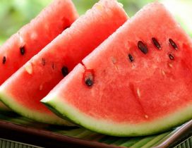 Three slices of watermelon on a tray