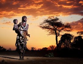 African woman holds her baby in arms