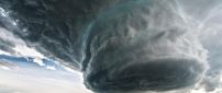 A storm with black cloud, lightning and tornado