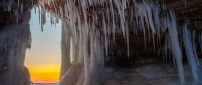 Sunset view from a cave full of icicle