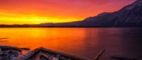 Orange sunset over a mountain lake