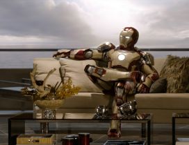 Iron Man sits on a sofa