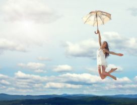 The girl flies with her umbrella
