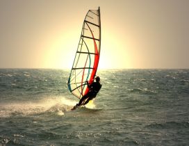 Windsurfing in the sunrise on the sea