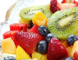 Colorful fruit salad in glass bowl