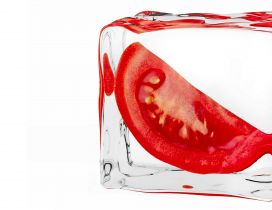 A slice of tomato in a ice cube