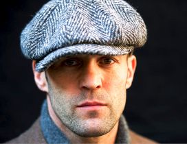 Jason Statham with a gray hat