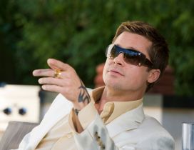 Brad Pitt in a white suit and sunglasses