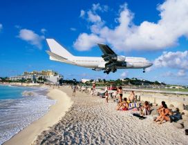 Airplane above the beach ready to land