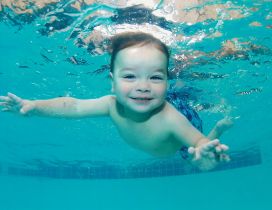 A cute baby swimming under water