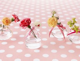 Romantic flowers with bows in bottles