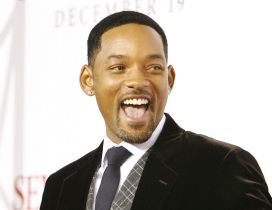 Will Smith in suit and tie with smile on face