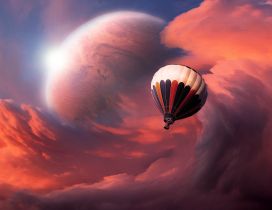 A balloon flying in the sky with interesting clouds