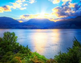 Relaxing landscape with water, mountains and sunlight