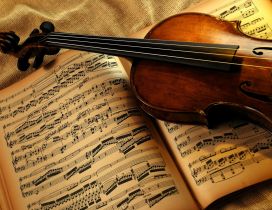 A violin on a music book - Music wallpaper