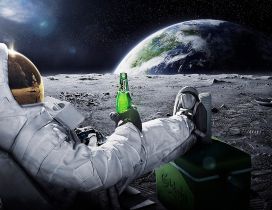 A men in space with a carlsberg beer