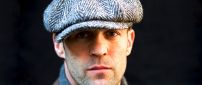 Jason Statham with a gray hat