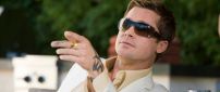 Brad Pitt in a white suit and sunglasses