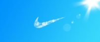 Nike logo by clouds on the blue sky