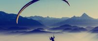 A man with paraglider over the mountains