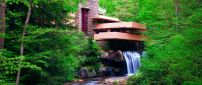 Building and waterfall in the green forest