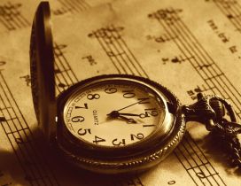 Pocket clock on a music book - Old Clock