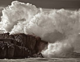 Big waves bump rocks - Dark wallpaper