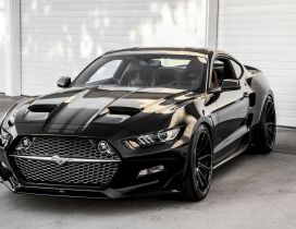 Beautiful black Ford Mustang Rocket in front of the garage