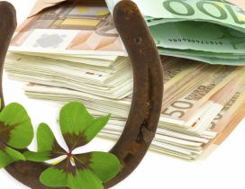 A horseshoe, a four leaf clover and a lot of money