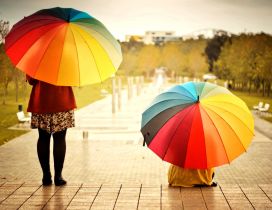 Two women with colorful umbrellas in the rain