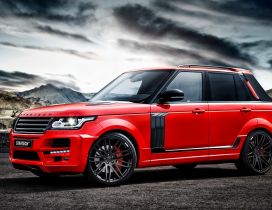 Red Startech Range Rover Pickup in the mountains