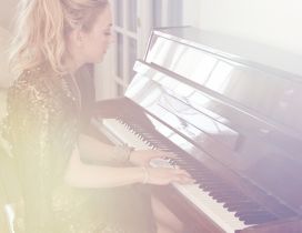 Emily Kinney, an American actress, playing the piano