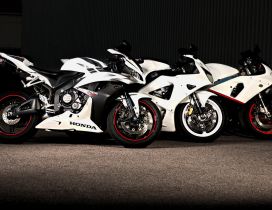Three white motorcycle honda sport