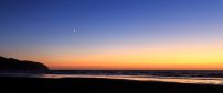 The moon on the clear sky - Sunset over the sea