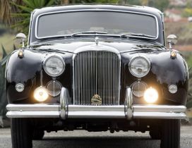 Black Classic Jaguar on road - Vintage car