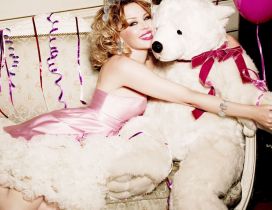 Kylie Minogue with a white plush bear