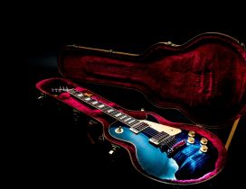Colorful guitar in a red cover - Music wallpaper