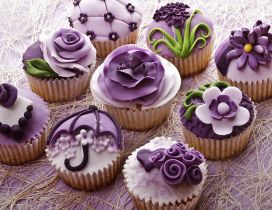 Muffins decorated with purple flowers made of sugar