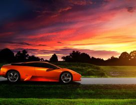 Orange Lamborghini Murcielago in the purple sunset